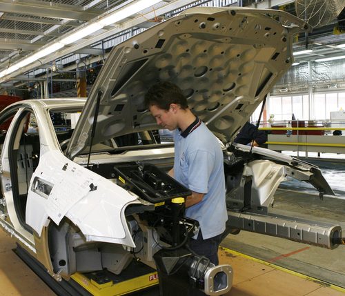 A supplied photo released Friday, August 15, 2008 of a manufacturing worker assembling a Holden car at the company's Elizabeth plant in South Australia. The Review of Australia's Automative Industry report, compiled over six months, concludes Australia should continue to invest in the sector despite recent closures to manufacturing plants across the industry. (AAP Image/GM Corp) NO ARCHIVING, EDITORIAL USE ONLY